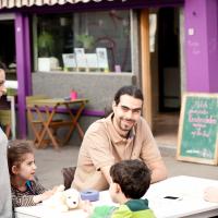 das Lokal Purple Eat. Vor dem Lokal sitzen Menschen und unterhalten sich. Foto: Christopher Glanzl