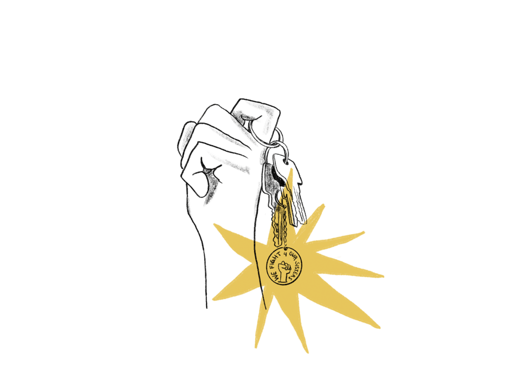 Hand made to a fist, holding keys including a keychain that says "we fight for our sisters"